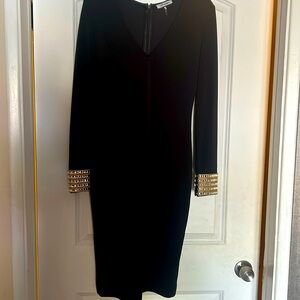 Gorgeous bodycon dress black with rhinestone cuffs. No tags but never worn.